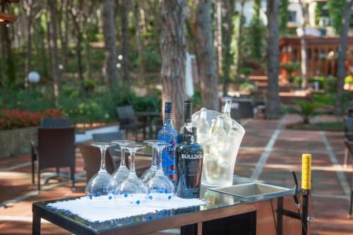 a table with wine bottles and glasses on it at Hotel Garbi in Calella de Palafrugell