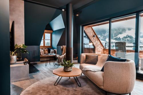 a living room with a couch and a table at Schlosshotel Kitzbühel in Kitzbühel