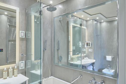 a bathroom with a shower and a sink and a mirror at Hotel Santa Chiara in Venice