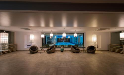 a large room with couches and a large window at Flora Garden Ephesus Kusadasi - All Inclusive in Davutlar
