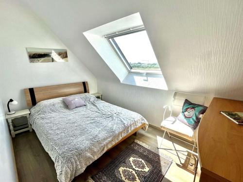 a small bedroom with a bed and a window at Étel: Appartement 2 pièces 37 m² - Balcon et Parking - FR-1-479-201 in Étel
