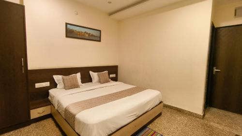 a bedroom with a large bed in a room at Hotel Udaipur Stay at Prime Location in Udaipur