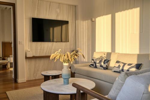 a living room with a couch and a table at Avant Mar Paros in Naousa