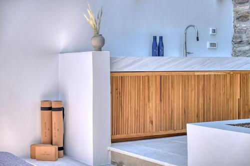 a kitchen with a sink and a wooden cabinet at Avant Mar Paros in Naousa