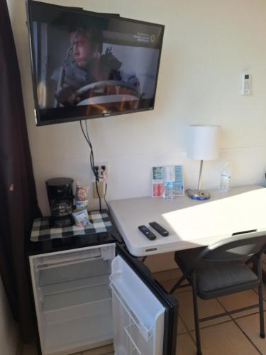 a tv hanging on a wall above a desk at #38 Bungalow Seaside Hotel & Victors RV Park in San Felipe