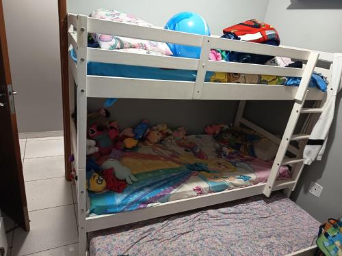 a white bunk bed with toys on it at ApartamentoA306 in Ananindeua