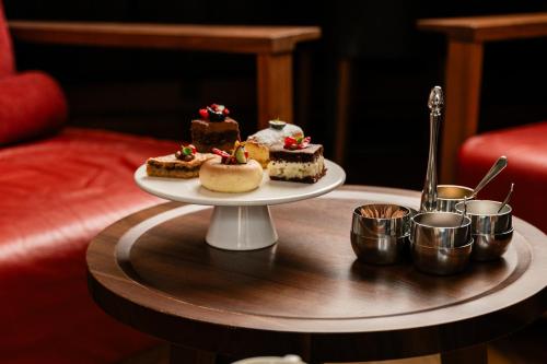 a table with a plate of desserts on a table at Waldhotel Stuttgart in Stuttgart