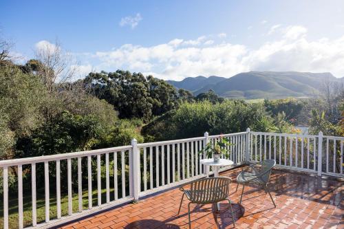 a patio with two chairs and a table and a fence at Stanford River Retreat in Stanford