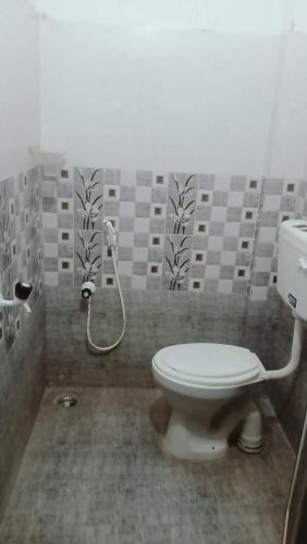 a bathroom with a toilet and a shower at Raju Residency in Visakhapatnam