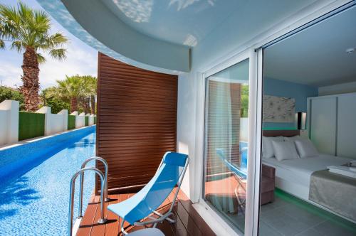 a bedroom with a bed and a swimming pool at Flora Garden Ephesus Kusadasi - All Inclusive in Davutlar