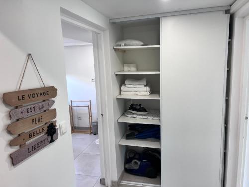 a room with a closet with shelves and a mirror at Appart Jardin Lac Casino Enghien Les Bains 15 min Paris in Soisy-sous-Montmorency