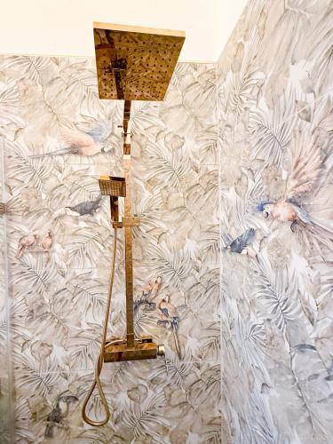 a lamp in a room with a wall at Elysium Suits Maximum Comfort in Punta Cana