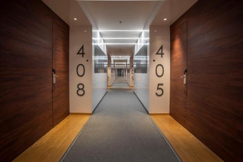 a hallway with four numbers on the walls at voco Guadalajara Neruda by IHG in Guadalajara