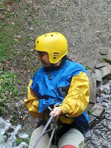 a young child wearing a yellow helmet sitting on a raft at Ecoterra Inka Lodge in Santa Ana