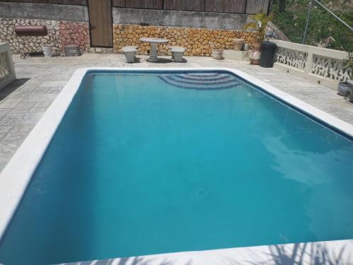 a swimming pool with blue water in a backyard at Bayview Luxury Retreat 