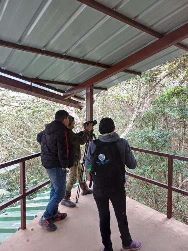 a group of people standing on a bridge taking a picture at Ecoterra Inka Lodge in Santa Ana