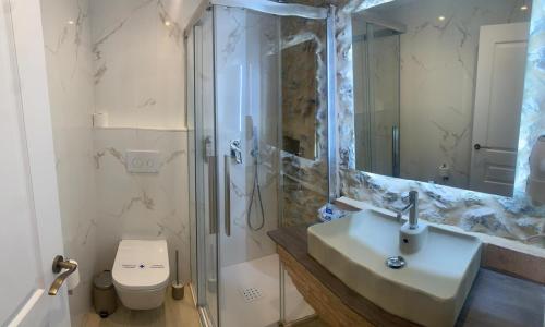 a bathroom with a shower and a sink and a toilet at La Quinta Luxury Palace in Arnuero