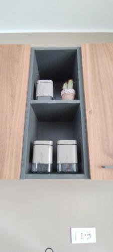 a shelf in a cabinet with dishes in it at Tra mare e collina in Condrò