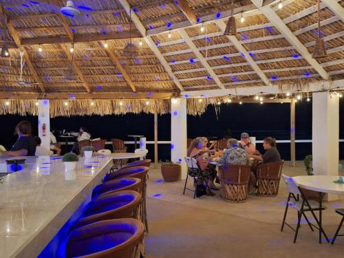 a group of people sitting at tables in a restaurant at #38 Bungalow Seaside Hotel & Victors RV Park in San Felipe