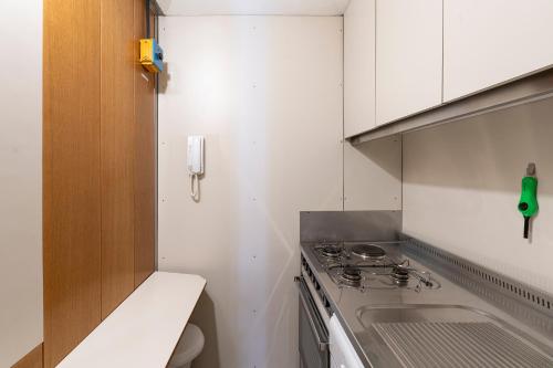 a small kitchen with a stove and a sink at Anzolo Palace - Rooms & Apartments in Venice