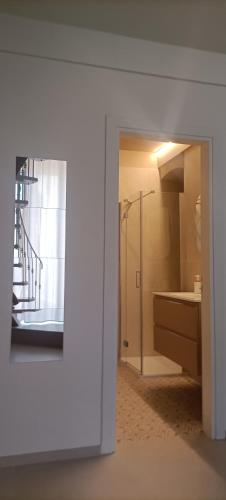 a bathroom with a walk in shower and a sink at b&b Castrum in Terlizzi