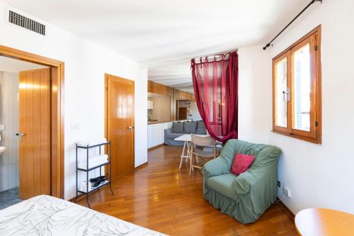 a living room with a couch and a chair at Anzolo Palace - Rooms & Apartments in Venice