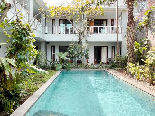 a swimming pool in front of a house at Bali Bliss Residence in Seminyak