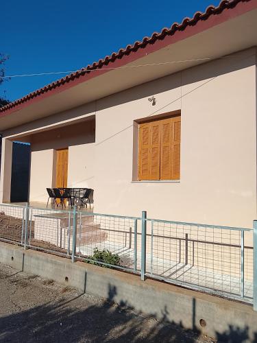 a white house with a table in front of it at DORA'S HOUSE Douneika in Amaliás