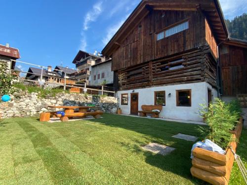 a house with a large yard with a building at Chalet le Dolomiti in Borca di Cadore