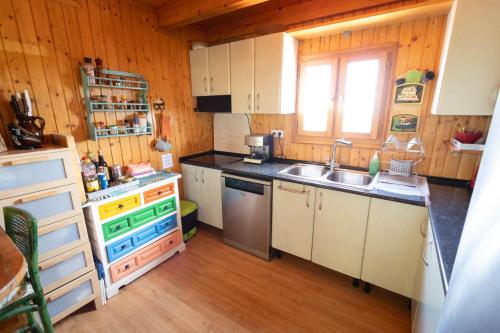 a small kitchen with a sink and a stove at Chalet, breathtaking sea view with large jacuzzi in Almuñécar