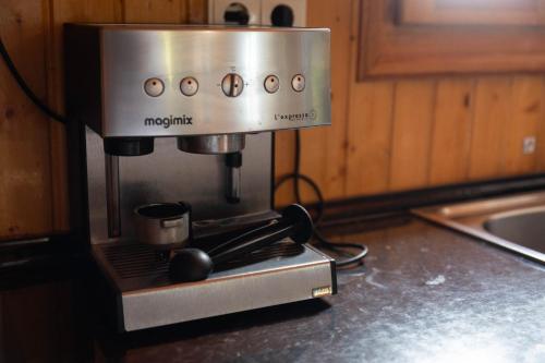 a coffee maker sitting on a counter in a kitchen at Chalet, breathtaking sea view with large jacuzzi in Almuñécar