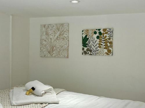 a bedroom with two paintings on the wall and a bed at Studio Dore Fshh in Nice