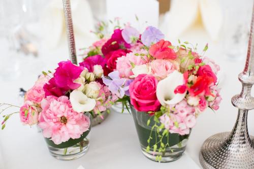 three vases filled with pink and pink flowers on a table at Waldhotel Stuttgart in Stuttgart