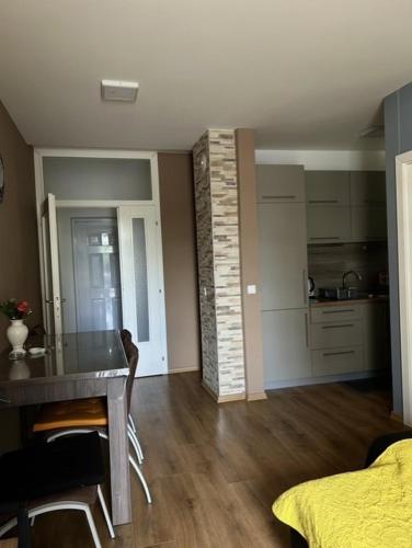 a living room with a table and a kitchen at Apartment Nikoloski in Struga