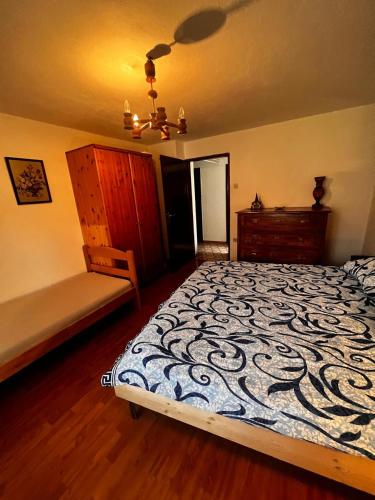 a bedroom with a bed and a bench in it at Apartma Pr'Csrlu 