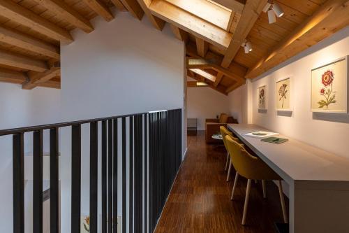 a kitchen and dining room with a table and yellow chairs at Grow Green in Caponago