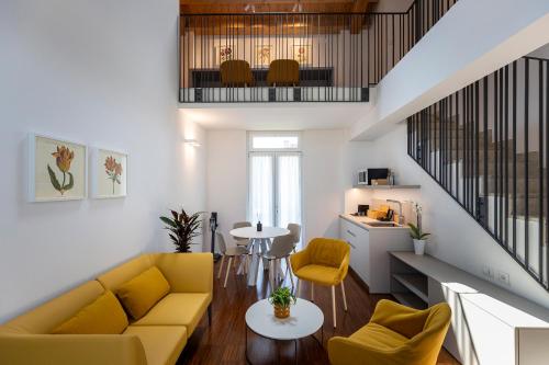 a living room with a yellow couch and a table at Grow Green in Caponago
