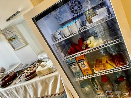 an open refrigerator filled with food and drinks at Innsud in Nardò