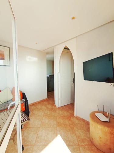 a living room with a flat screen tv on a wall at Mirleft Horizon Suites in Mirleft