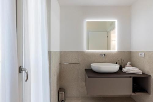 a bathroom with a sink and a mirror on a counter at Grow Green in Caponago