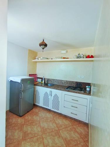 a kitchen with a sink and a refrigerator at Mirleft Horizon Suites in Mirleft