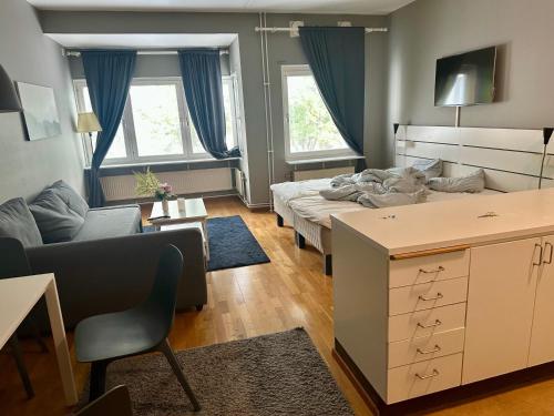 a living room with a bed and a couch at Skarholmen Stockholm Apartment in Stockholm