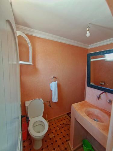 a bathroom with a toilet and a sink at Mirleft Horizon Suites in Mirleft