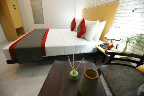 a bedroom with a large bed and a couch at Hotel The Anvi Residency in Noida