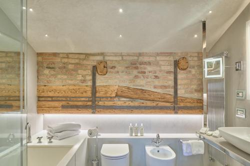 a bathroom with a toilet and a sink at Hotel Santa Chiara in Venice
