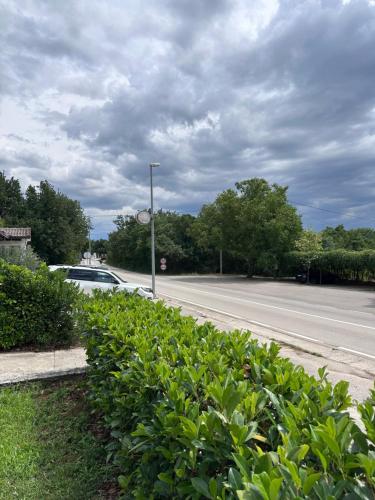 a street with a car parked on the side of a road at Apartmani Novak in Mostar