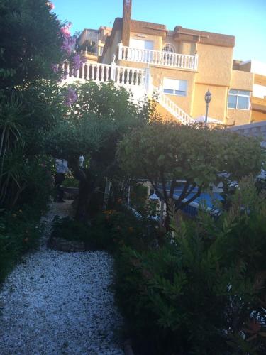 a garden in front of a building at HOLIDAY CHALET BENIDORM in Benidorm