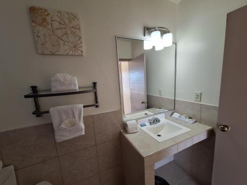 a bathroom with a sink and a mirror at #53 Bungalow Seaside Hotel & Victors RV Park in San Felipe