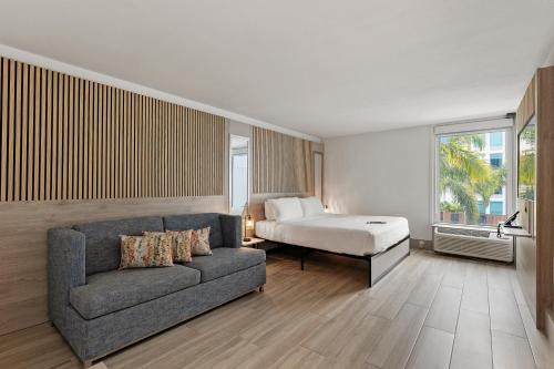 a living room with a couch and a bed at Kompose Boutique Resort @ Theme Parks in Kissimmee
