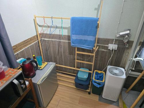 a small bathroom with a toilet and a towel at 113 Olan Place Cozy Loft Apartment with free Wi-fi in Bangkok